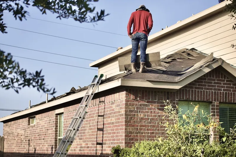Professional roofer working on a residential roof in Hollywood by the Lake